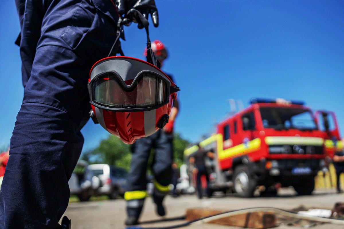 Firefighter paramedic walking toward fire truck