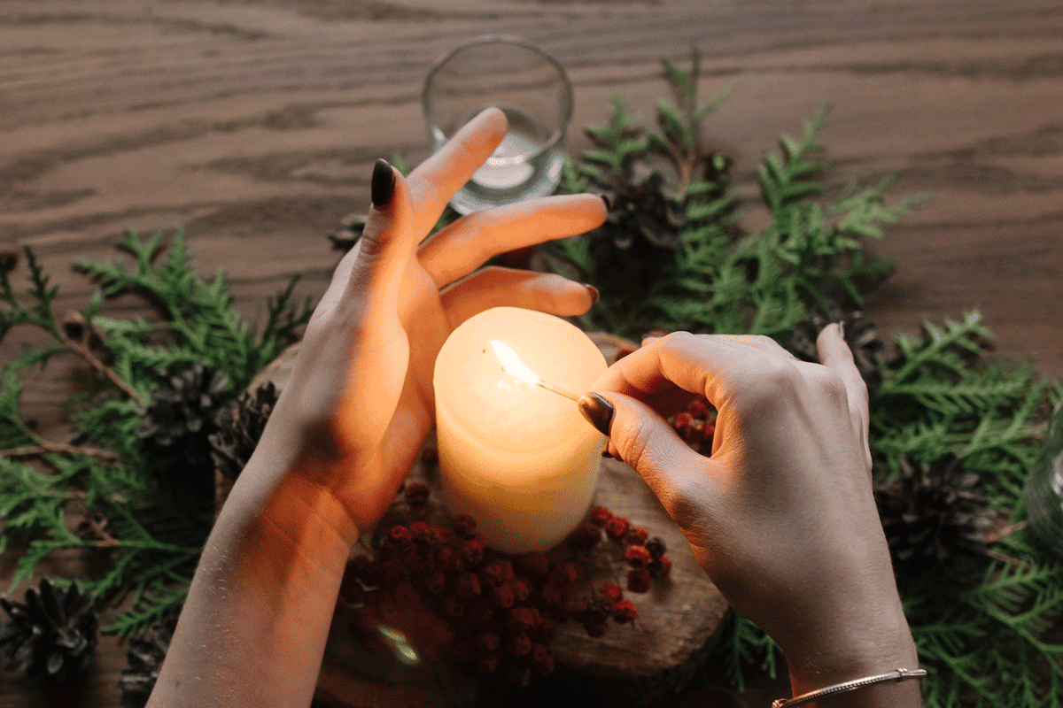 Hands lighting flammable paraffin wax